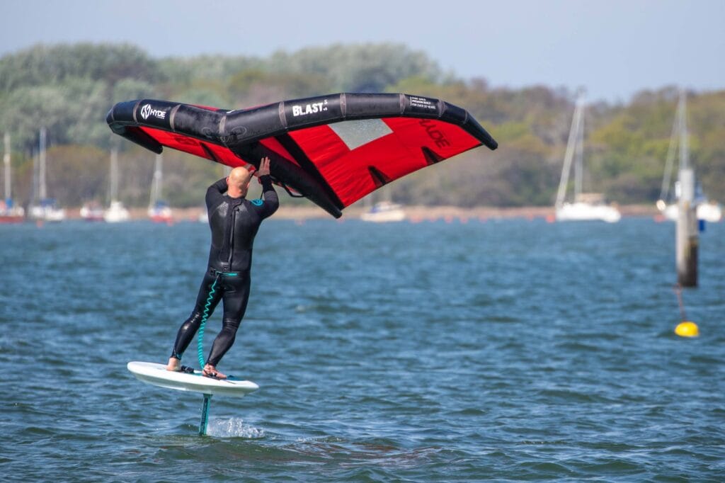 Wing foiling in the sunshine on flat water